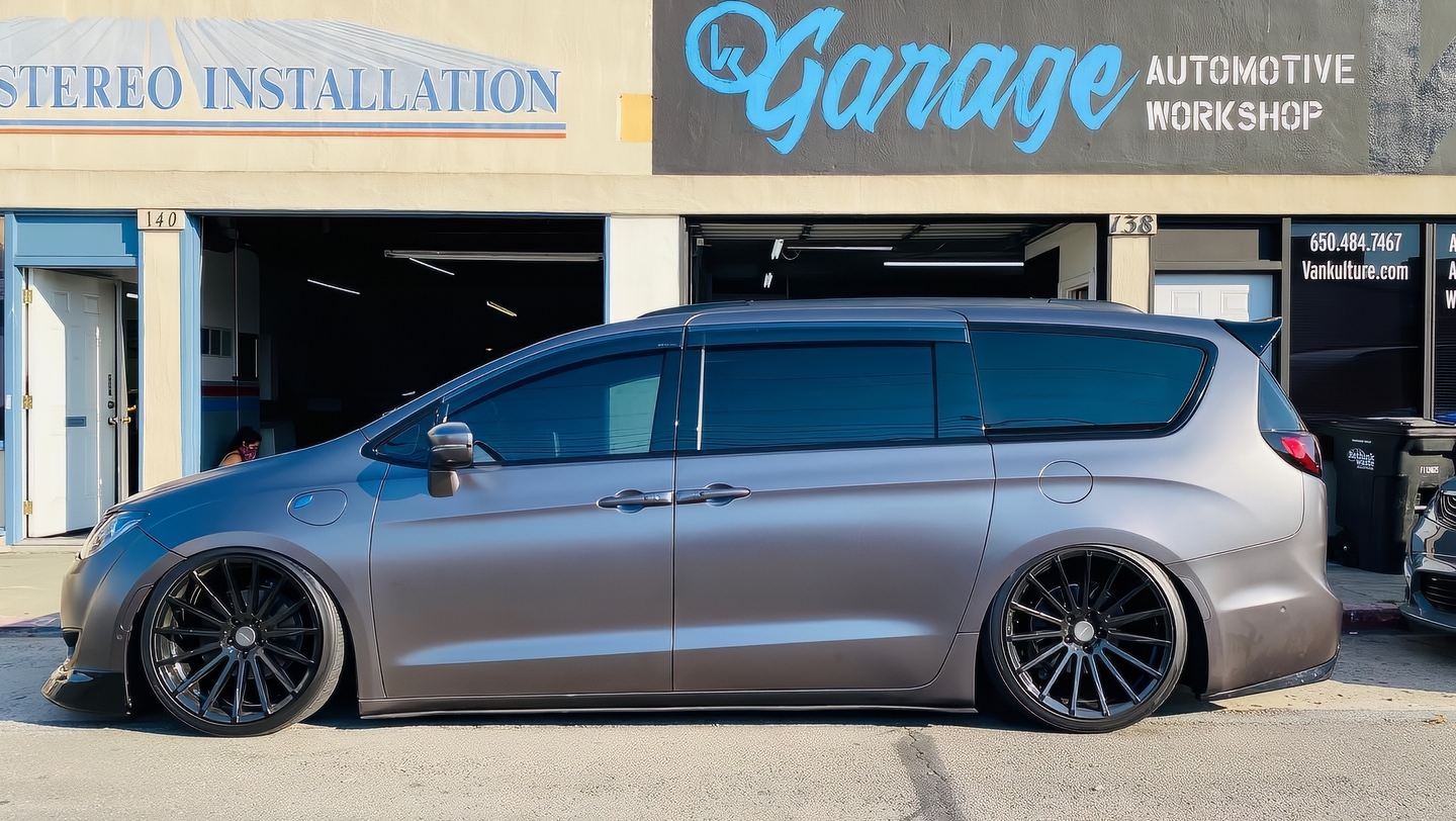 Custom van with tinted windows parked outside the VK Garage workshop